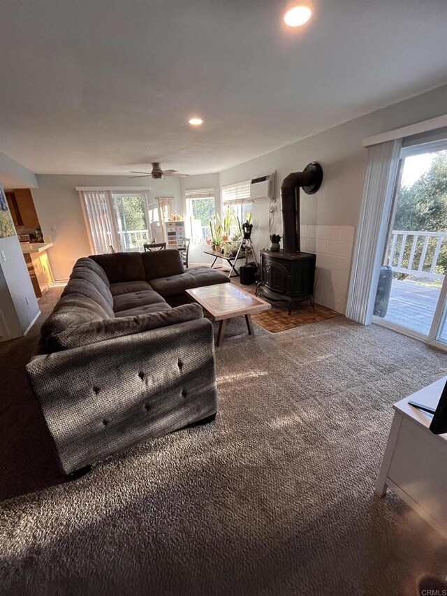 8606 Valley View Trl, Pine Valley, CA 91962 - carpeted living room featuring an AC wall unit, a wood stove, plenty of natural light, recessed lighting, and a ceiling fan