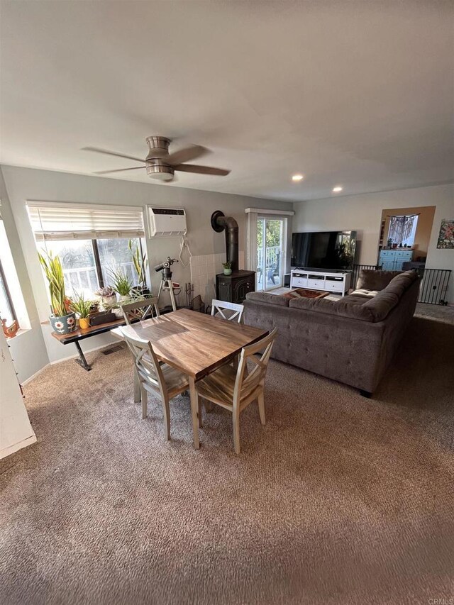 8606 Valley View Trl, Pine Valley, CA 91962 - dining space with a wood stove, carpet floors, ceiling fan, recessed lighting, and an AC wall unit