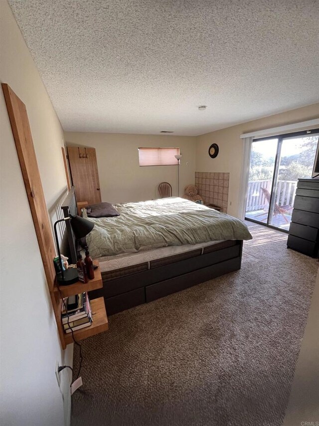 8606 Valley View Trl, Pine Valley, CA 91962 - carpeted bedroom featuring access to exterior and a textured ceiling