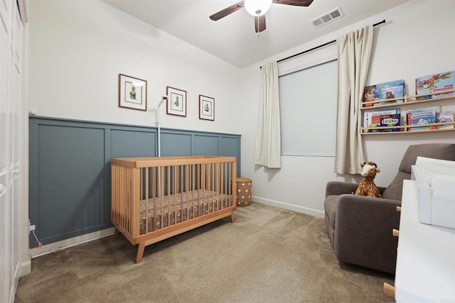 3520 Conner Way, Oceanside, CA 92056 - bedroom featuring carpet floors, a crib, a wainscoted wall, a decorative wall, and ceiling fan