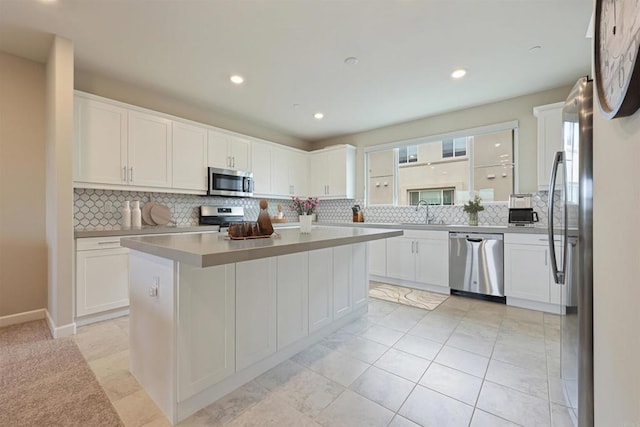 3520 Conner Way, Oceanside, CA 92056 - kitchen featuring stainless steel appliances, backsplash, white cabinetry, a kitchen island, and recessed lighting