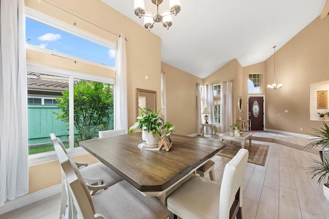 653 Diamond Dr, Chula Vista, CA 91911 - dining area featuring a chandelier, light wood finished floors, and high vaulted ceiling