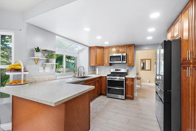 653 Diamond Dr, Chula Vista, CA 91911 - kitchen featuring appliances with stainless steel finishes, a peninsula, brown cabinets, recessed lighting, and open shelves
