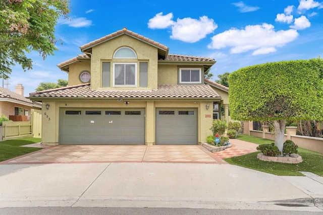 653 Diamond Dr, Chula Vista, CA 91911 - mediterranean / spanish-style house featuring a tile roof, an attached garage, concrete driveway, and stucco siding