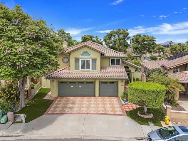 653 Diamond Dr, Chula Vista, CA 91911 - mediterranean / spanish-style house with a tile roof, stucco siding, a garage, and concrete driveway