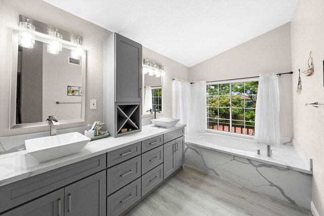 653 Diamond Dr, Chula Vista, CA 91911 - full bath featuring double vanity, lofted ceiling, wood finished floors, and a bath