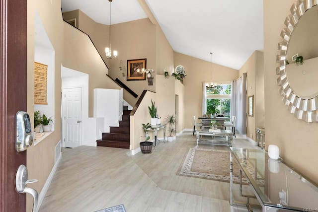 653 Diamond Dr, Chula Vista, CA 91911 - foyer entrance with a chandelier, high vaulted ceiling, stairs, and wood finished floors