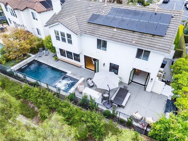 23 Fawnridge Pl, Aliso Viejo, CA 92656 - back of house with a fenced backyard, stucco siding, and solar panels
