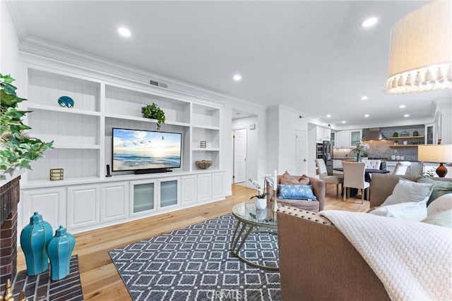 23 Fawnridge Pl, Aliso Viejo, CA 92656 - living room with ornamental molding, light wood-style flooring, recessed lighting, and built in features