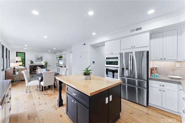 23 Fawnridge Pl, Aliso Viejo, CA 92656 - kitchen featuring stainless steel appliances, wooden counters, white cabinetry, decorative backsplash, and recessed lighting