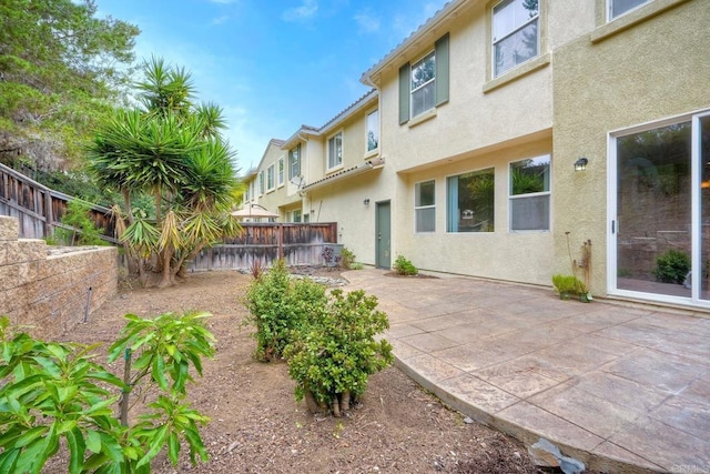 4049 Peninsula Dr, Carlsbad, CA 92010 - rear view of house featuring a fenced backyard, a patio area, and stucco siding