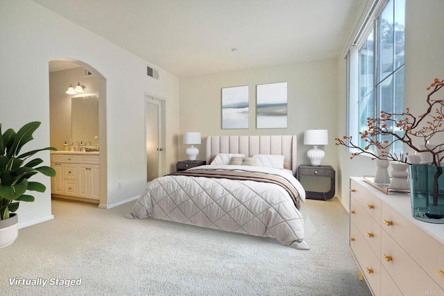 4049 Peninsula Dr, Carlsbad, CA 92010 - bedroom featuring arched walkways, light carpet, and ensuite bath