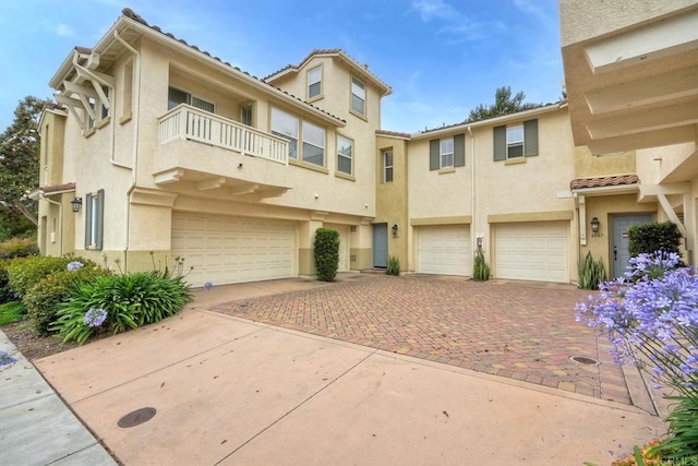 4049 Peninsula Dr, Carlsbad, CA 92010 - view of front of property with an attached garage, a balcony, driveway, and stucco siding