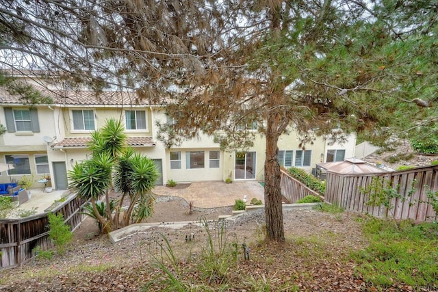 4049 Peninsula Dr, Carlsbad, CA 92010 - rear view of property featuring a fenced backyard, stucco siding, a patio area, and a gazebo
