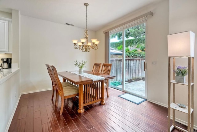 4049 Peninsula Dr, Carlsbad, CA 92010 - dining space featuring dark wood finished floors and a chandelier