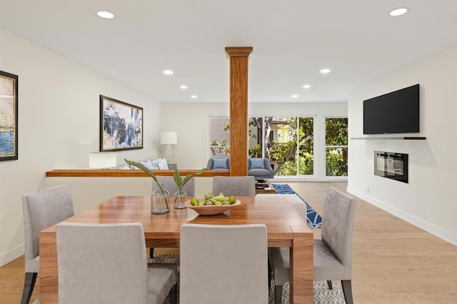 2610 Torrey Pines Rd Unit C21, La Jolla, CA 92037 - dining room featuring recessed lighting, light wood finished floors, and a glass covered fireplace