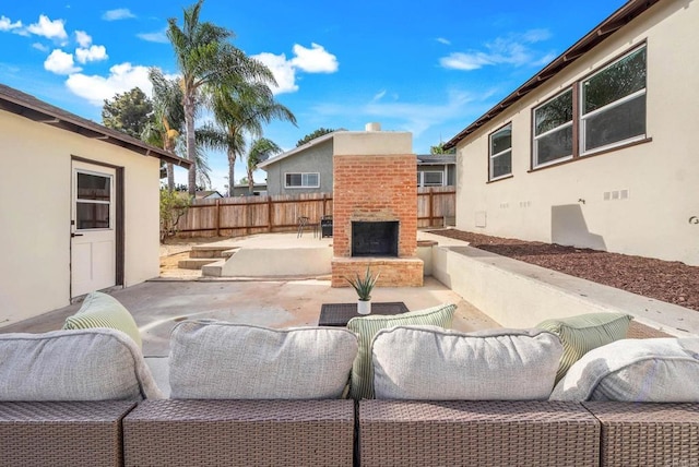 640 Pyramid St, San Diego, CA 92114 - fenced backyard with a patio area and an outdoor living space with a fireplace