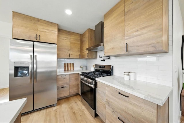 640 Pyramid St, San Diego, CA 92114 - kitchen featuring appliances with stainless steel finishes, wall chimney exhaust hood, light wood-style flooring, tasteful backsplash, and recessed lighting