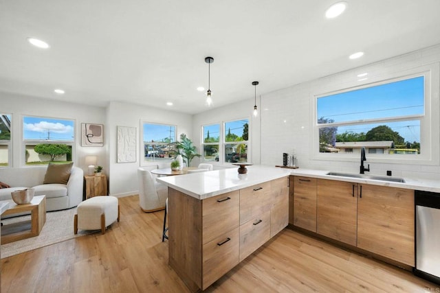 640 Pyramid St, San Diego, CA 92114 - kitchen with stainless steel dishwasher, modern cabinets, light wood-type flooring, a peninsula, and recessed lighting