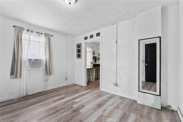 671 N Cherry St, Banning, CA 92220 - empty room with wood finished floors, cooling unit, and baseboards