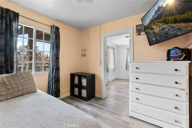 671 N Cherry St, Banning, CA 92220 - bedroom with light wood-type flooring, multiple windows, and baseboards