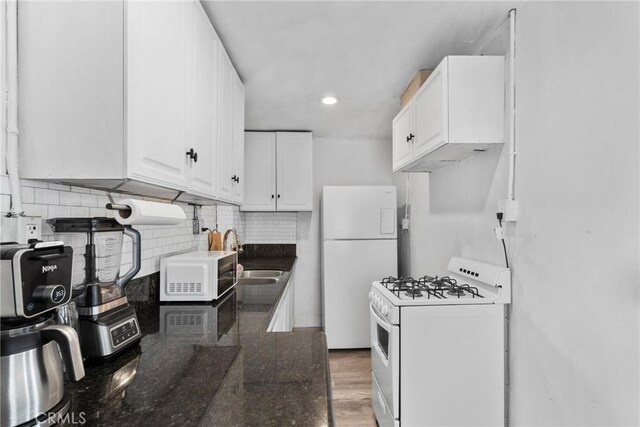 671 N Cherry St, Banning, CA 92220 - kitchen with white appliances, a sink, white cabinetry, tasteful backsplash, and recessed lighting