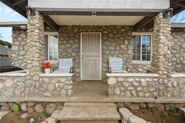671 N Cherry St, Banning, CA 92220 - entrance to property featuring stone siding and a porch