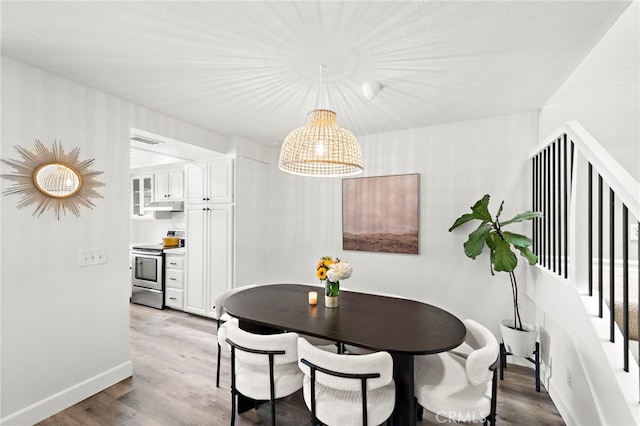 917 Hyde Ct, Costa Mesa, CA 92626 - dining space with wood finished floors, a chandelier, and stairway