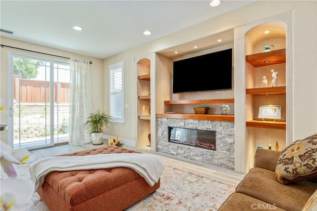2747 Traditions Loop, Paso Robles, CA 93446 - living area with built in shelves, a fireplace, wood finished floors, and recessed lighting