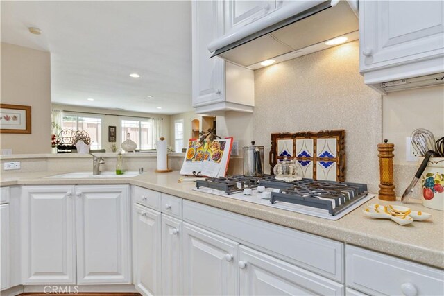 2747 Traditions Loop, Paso Robles, CA 93446 - kitchen featuring white gas stovetop, white cabinets, light countertops, under cabinet range hood, and recessed lighting