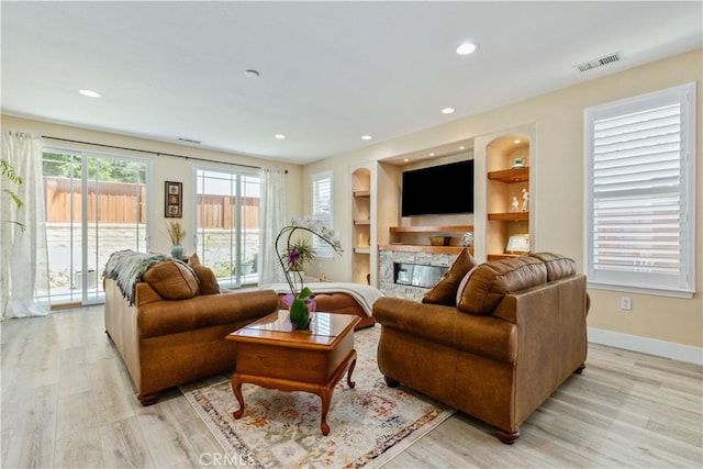 2747 Traditions Loop, Paso Robles, CA 93446 - living area featuring a high end fireplace, light wood-style floors, and recessed lighting