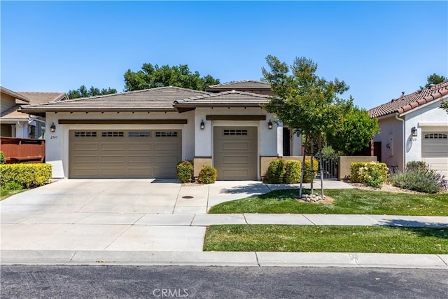 2747 Traditions Loop, Paso Robles, CA 93446 - view of front of house with an attached garage, a tiled roof, stucco siding, and driveway