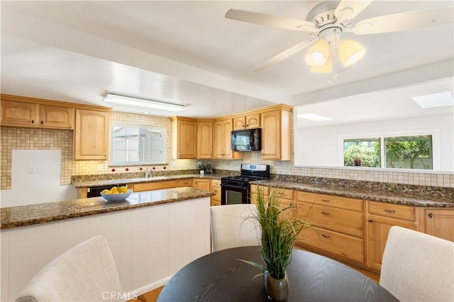 10402 Oronsay Cir, Huntington Beach, CA 92646 - kitchen with black appliances, tasteful backsplash, dark stone countertops, and ceiling fan