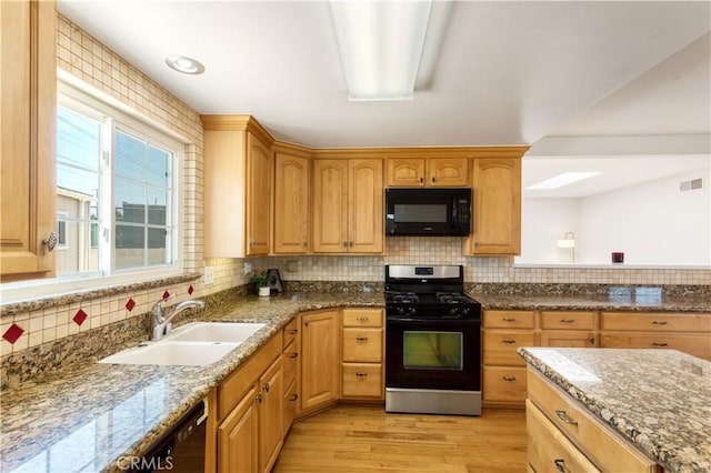 10402 Oronsay Cir, Huntington Beach, CA 92646 - kitchen with black microwave, stainless steel gas range, light wood-type flooring, backsplash, and stone counters