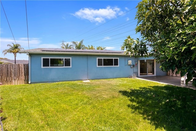 10402 Oronsay Cir, Huntington Beach, CA 92646 - rear view of house featuring stucco siding, roof mounted solar panels, and a patio area