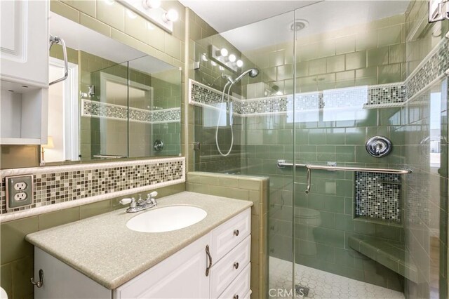 10402 Oronsay Cir, Huntington Beach, CA 92646 - full bathroom with tile walls, vanity, and a stall shower