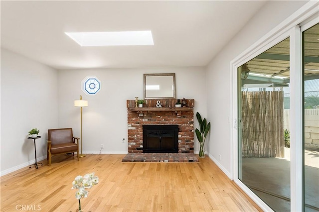 10402 Oronsay Cir, Huntington Beach, CA 92646 - living room with a skylight, wood finished floors, and a brick fireplace