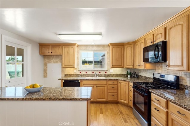 10402 Oronsay Cir, Huntington Beach, CA 92646 - kitchen featuring black appliances, light wood finished floors, dark stone counters, and plenty of natural light