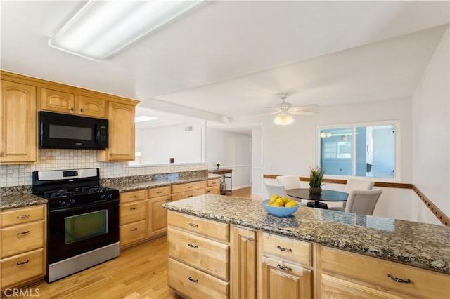 10402 Oronsay Cir, Huntington Beach, CA 92646 - kitchen with range with gas stovetop, black microwave, light brown cabinetry, and light wood-style flooring