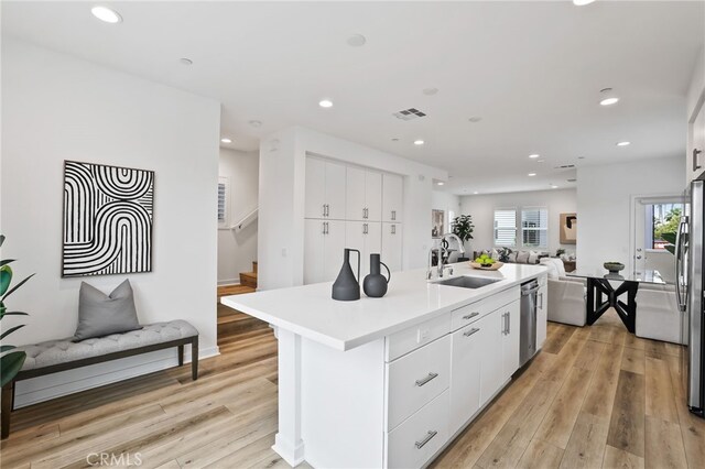 536 Caleigh Ln, Costa Mesa, CA 92627 - kitchen with a sink, open floor plan, stainless steel appliances, recessed lighting, and white cabinetry