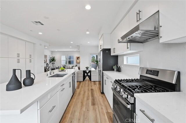 536 Caleigh Ln, Costa Mesa, CA 92627 - kitchen with stainless steel appliances, under cabinet range hood, a sink, recessed lighting, and white cabinetry