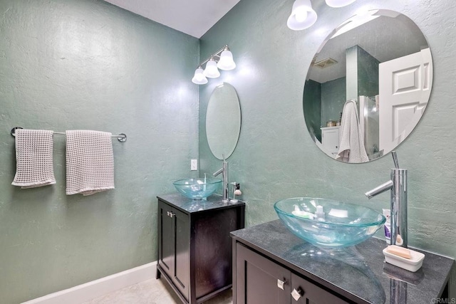5431 Stirrup Way, Oceanside, CA 92057 - bathroom with two vanities and a textured wall