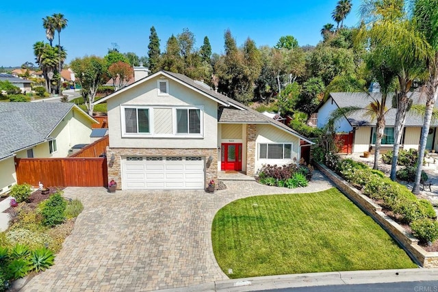 5431 Stirrup Way, Oceanside, CA 92057 - view of front of home featuring stone siding, an attached garage, decorative driveway, and stucco siding