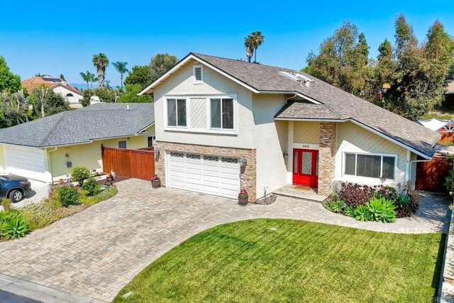 5431 Stirrup Way, Oceanside, CA 92057 - view of front of property with stone siding, stucco siding, decorative driveway, and a garage