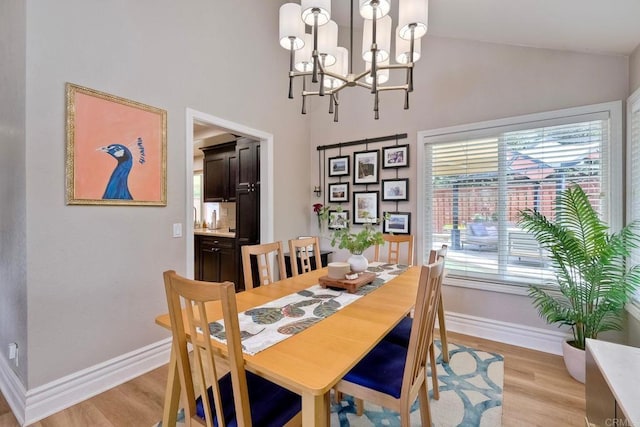 5431 Stirrup Way, Oceanside, CA 92057 - dining area with light wood-type flooring, high vaulted ceiling, and a chandelier