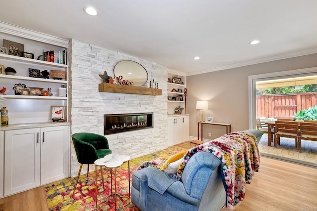 5431 Stirrup Way, Oceanside, CA 92057 - living room with light wood finished floors, built in shelves, ornamental molding, a fireplace, and recessed lighting