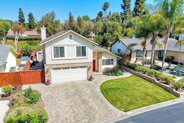 5431 Stirrup Way, Oceanside, CA 92057 - view of front facade with decorative driveway, an attached garage, stone siding, stucco siding, and a chimney
