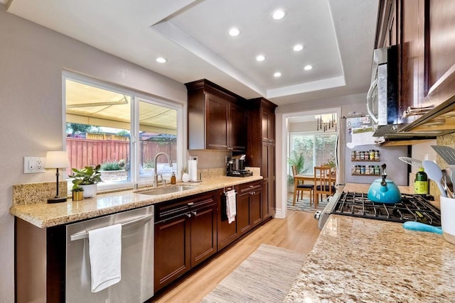 5431 Stirrup Way, Oceanside, CA 92057 - kitchen featuring stainless steel appliances, light wood finished floors, a raised ceiling, light stone counters, and recessed lighting