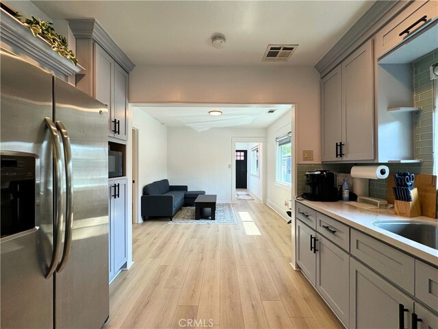 210 Amabel St, Los Angeles, CA 90065 - kitchen with stainless steel refrigerator with ice dispenser, gray cabinetry, light wood finished floors, and light countertops