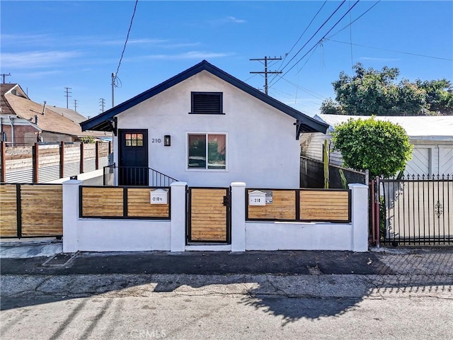 210 Amabel St, Los Angeles, CA 90065 - view of front facade with a fenced front yard, stucco siding, and a gate